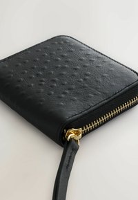 Black leather wallet with a textured surface featuring small dots, gold zipper hardware, and a wrist strap. Rectangular shape.