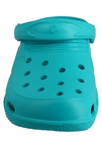 Turquoise clogs featuring a closed toe, ventilation holes, a raised back strap, and a textured sole for grip. Made of lightweight material.