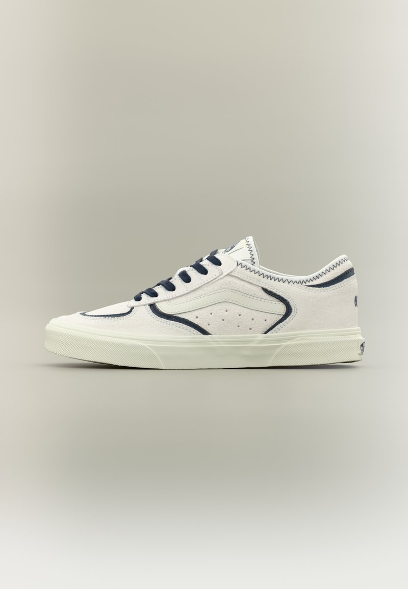 Λευκά πάνινα αθλητικά παπούτσια με ναυτικό μπλε λεπτομέρειες, στρογγυλή μύτη, σχέδιο με κορδόνια, διάτρητη λεπτομέρεια στο πλάι και υφασμένη σόλα από καουτσούκ.