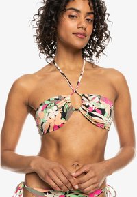 Bikini top met een bloemenpatroon in roze, wit en groen op een zwarte achtergrond, met een twist-front ontwerp en halternekbanden.