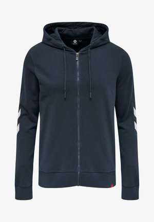 Navy gebreide hoodie met ritssluiting, voorzien van een trekkoordcapuchon, ribgebreide manchetten en zoom, en witte chevronpatronen op de mouwen. Gemaakt van een katoenmix.