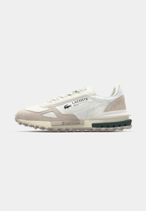 Lacoste sneakers with a white textile upper, beige suede accents, textured sole, and logo detail on the side. Round laces and padded collar.