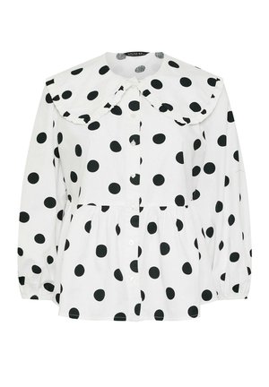 White shirt with large black polka dots, featuring a Peter Pan collar, button-down front, and gathered waist with long sleeves.
