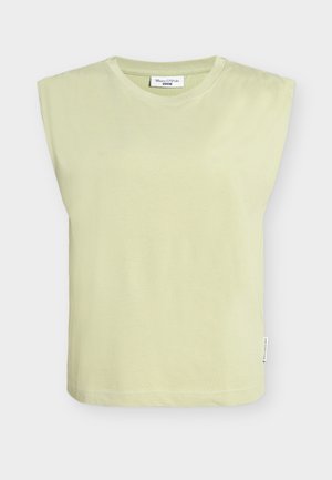 Light green cotton top with wide shoulder design, round neckline, and a straight hem. Features a tag at the side seam.