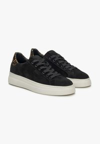 Black suede sneakers feature a white rubber sole, gray laces, and a leopard-print accent on the heel. Smooth texture with a minimalist design.