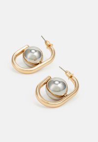 Gold-tone hoop earrings with a shiny silver sphere. Features a streamlined design with a smooth finish and a secure post back.