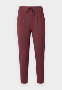 Burgundy dragpantaloner gjorda av mjukt, stretchigt material. Har en dragsko i midjan och smalnande ben med en jämn, enfärgad textur.