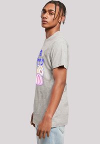 Gray cotton t-shirt featuring colorful cartoon graphics on the front. Short sleeves, crew neck, relaxed fit, and smooth texture.