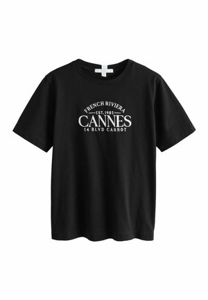 Schwarzes T-Shirt mit kurzen Ärmeln und weißem Text in der Mitte auf der Vorderseite: "French Riviera EST. 1982 Cannes 14 Blvd Carnot".