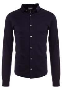 Chemise à manches longues bleu marine à boutons, avec un col classique, ornée de boutons en argent et d'une texture lisse. Coupe ajustée et ourlet droit.