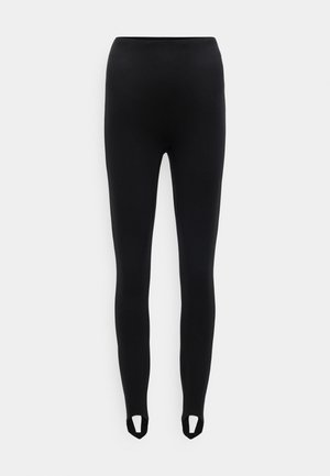 Leggings negros confeccionados con un material elástico y textura suave. Cuentan con recortes en el tobillo para un detalle adicional.