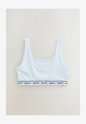 Valge lühendatud tank top laia rihmade ja elastse paelaga allosas, millele on musta värviga trükitud korduv "NEXT" tekst.