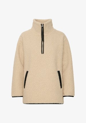Bež flis pulover s visokim ovratnikom, pola zip zatvaranjem sprijeda i crnim bočnim džepovima. Mekana tekstura s lagano prekomjernim krojem.