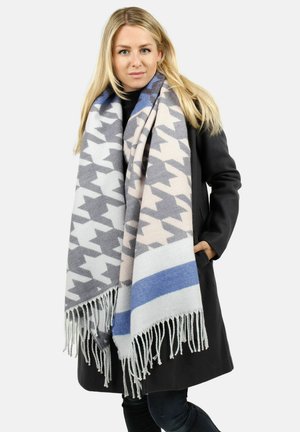 Large houndstooth patterned scarf in soft fabric, featuring gray, beige, and blue colors with fringe detailing at the ends.