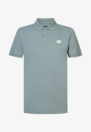Polo shirt in light blue fabric, featuring a two-button placket and ribbed collar, with a small logo on the chest.