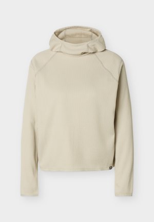 Beige väritetty pitkähihaiset huppari, jossa on rento istuvuus ja ommellut raglan-saumat, esillä yksinkertaisella valkoisella taustalla.