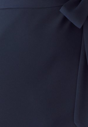 Navy fabric with a smooth texture, featuring a side bow detail. The material appears lightweight and soft, with a subtle sheen.