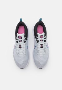 Grå och svarta träningsskor med rosa och teal detaljer. Nätövre, snörning, strukturerad sula och logotypdetalj på tungan.