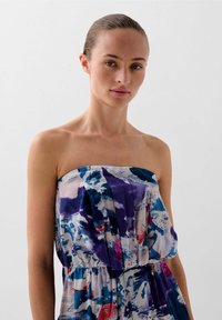 Strapless dress in lightweight fabric featuring a multicolored abstract pattern of blue, purple, and pink with a gathered waist design.
