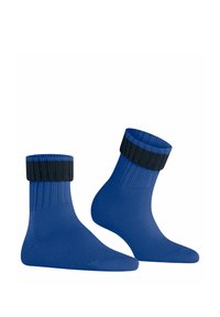 Calze blu con una texture a coste, dotate di una cima a coste nera. Design alla caviglia, finitura liscia e costruzione robusta.