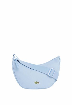Light blue crossbody bag with adjustable strap and small green crocodile logo on front, zipper closure at the top.