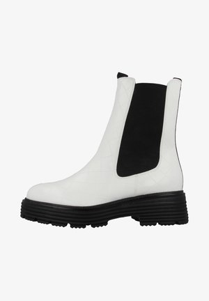 White quilted leather ankle boot with a black elastic panel, rounded toe, and a chunky black rubber sole. Side pull tab included.