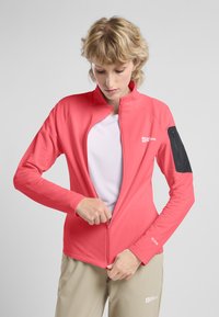 Leichte rosa Jacke mit hohem Kragen und Reißverschluss vorne. Verfügt über einen strukturierten Stoff und eine schwarze Reißverschlusstasche am Ärmel.