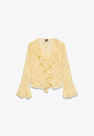 Blusa gialla con un davanti arruffato, maniche lunghe a campana e motivo floreale con accenti verdi. Tessuto leggero e semitrasparente.