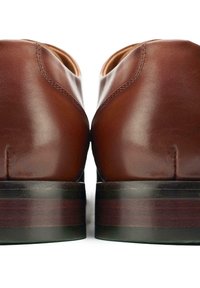 Brown leather shoes with a smooth texture, rounded shape, and contrasting layered wooden heel detail. Minimal stitching visible at the seams.