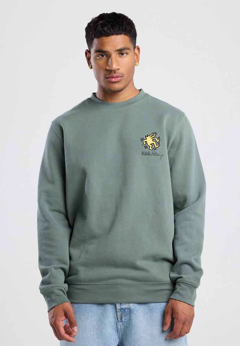 Green sweatshirt made of cotton blend, featuring a crew neck, long sleeves, and a yellow graphic logo on the chest.