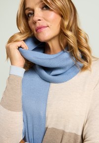 Lightweight knitted sweater with a cowl neck, featuring blue, beige, and taupe color blocks. Textured fabric with soft ribbing details.