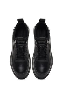 Zapatillas negras con parte superior de cuero suave, puntera redonda, cierre de cordones y lengüetas. Suela ligera con acentos texturizados.