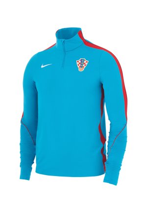 Jasnoniebieska sportowa bluzka z długim rękawem z czerwonymi paskami na rękawach, kołnierz z zamkiem do ćwiartki, logo Nike i herbem chorwackiej drużyny piłkarskiej na piersi.