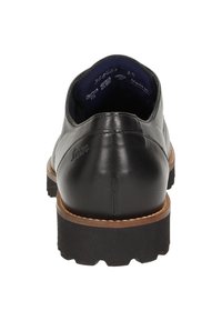 Chaussure en cuir noir avec un talon arrondi, semelle en caoutchouc texturée et coutures de couleur marron. L'intérieur présente un revêtement bleu avec des détails imprimés.