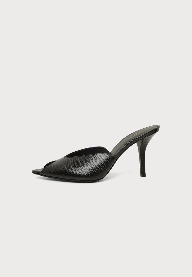 Mule noire à bout ouvert avec motif texturé et talon haut fin sur un fond clair uni.