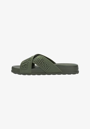 Green slide sandal with two crisscross straps, textured rubber material, and embossed brand name. Features a flat, ridged sole for grip.