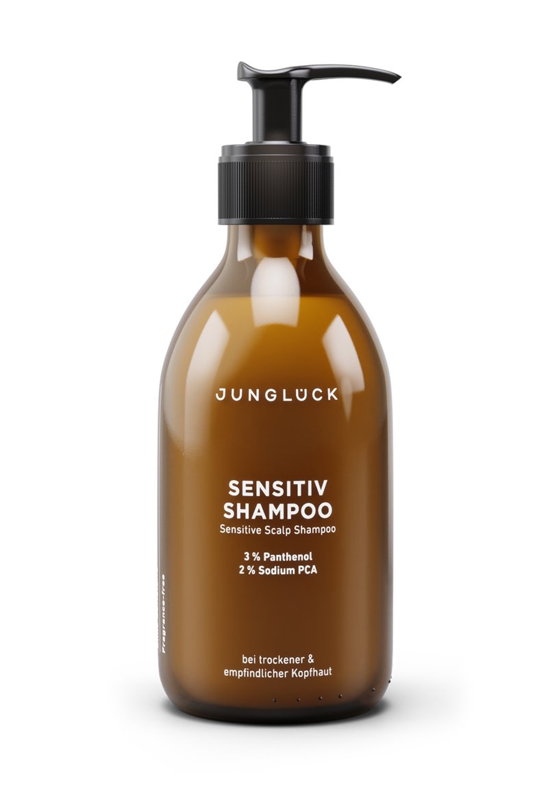 Braune Kunststoffflasche mit schwarzem Pumpspender. Weißer Text auf der Vorderseite lautet "SENSITIV SHAMPOO" und enthält Angaben zu den Inhaltsstoffen sowie Anwendungshinweise.