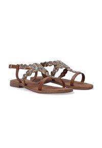 Brune flade sandaler med et bredt, dekorativt bånd med perle-accenter, en blød ruskindsindersål og en justerbar ankelspænde.