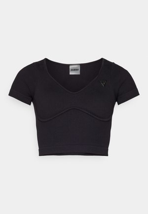 Crop top noir côtelé avec des manches courtes, décolleté en V et détail de couture incurvée. Présente un petit logo triangulaire sur l'épaule gauche.