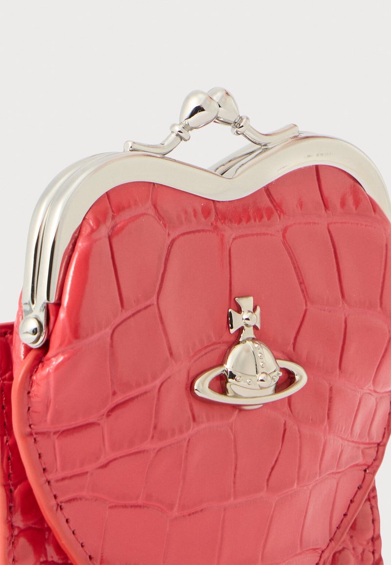 Red faux-crocodile leather purse with heart shape, silver-tone clasp and hardware, featuring a decorative planet design.
