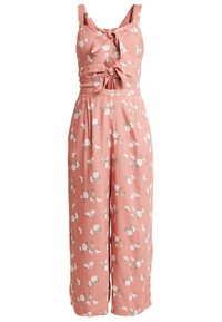 Ärmelloser rosa Floral-Overall mit weitem Bein, zwei vorderen Bindeknoten und kleinen Ausschnitten im Taillenbereich.