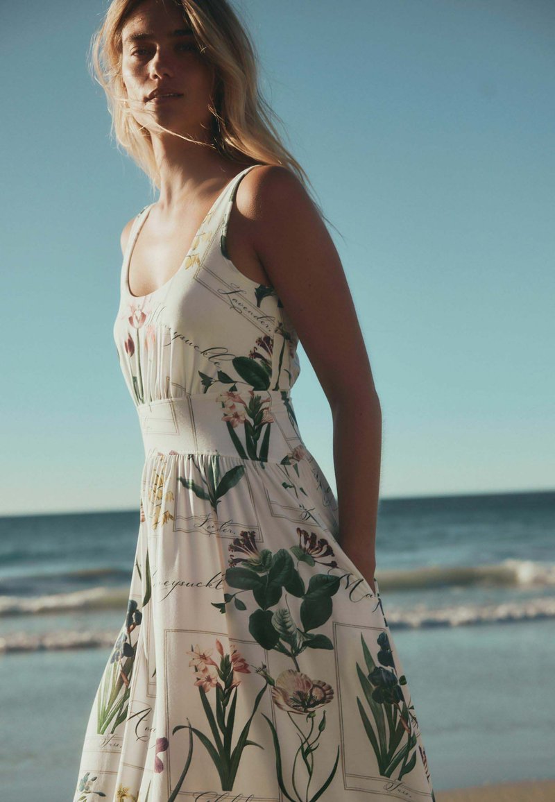 next beach dress Jersey - white floral print/white formal dresses 2026 MANGO - Ruffled striped Color:VERY BLACK Stretch knit fabric