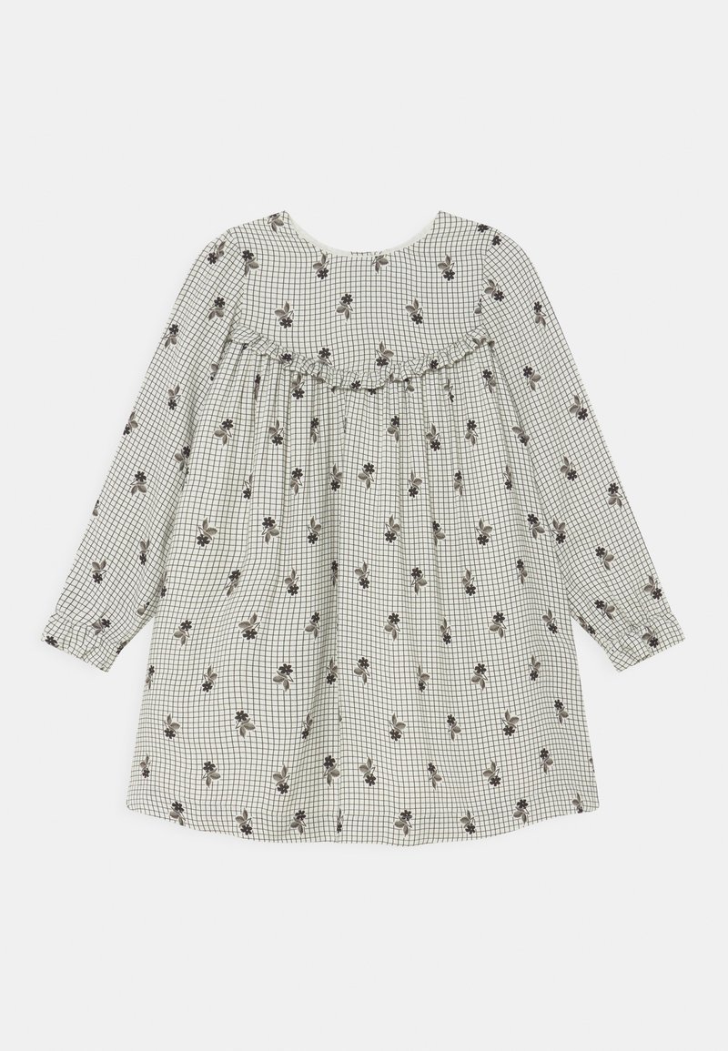 Vestido de mangas compridas feito de um tecido leve com um padrão xadrez e detalhes florais. Apresenta um decote franzido e um corte solto.