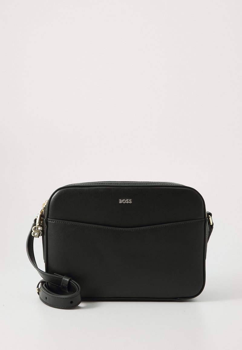 Black leather shoulder bag with a rectangular shape, featuring a logo on the front, a zip closure, and an adjustable strap. Smooth texture.