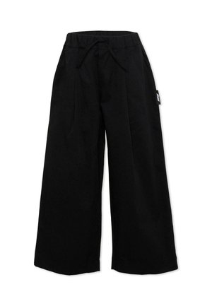Pantaloni neri a gamba larga con vita elastica e coulisse, con una piccola etichetta laterale sulla gamba destra, distesi su uno sfondo bianco.
