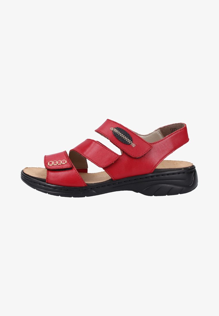 Red leather sandal with three adjustable Velcro straps, cushioned insole, and black rubber sole featuring a textured pattern for grip.