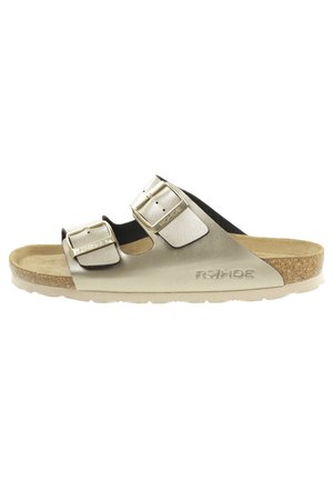 Metallic gold slide sandal with two adjustable straps, cork footbed, and textured rubber sole. Features embossed brand logo.