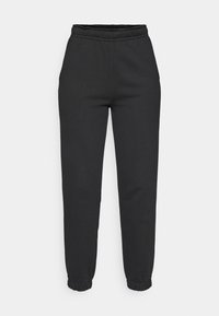 Svarte, tapered joggebukser med elastisk midje og mansjetter, frontlommer, laget av mykt stoff.