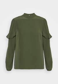 Olivgrön blus med hög krage, lång ärm och volangdetaljer vid axlarna. Slät textur och avslappnad passform.