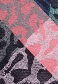 Multicolored fabric featuring a mix of pink, gray, and black animal print patterns; textured surface with a woven appearance.